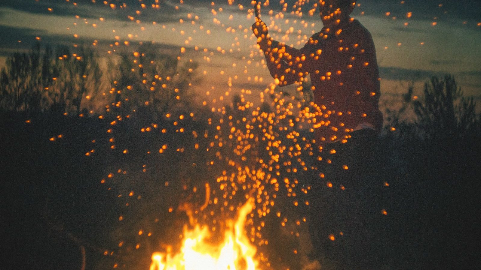 man playing bone fire Samhain feu de joie